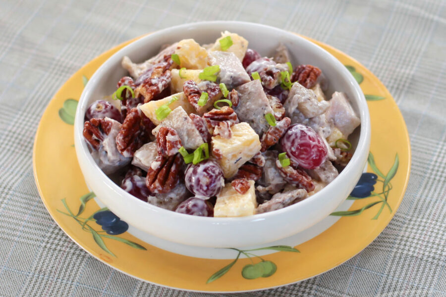 Grilled chicken salad with fruits and nuts