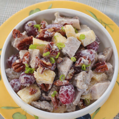 Grilled chicken salad with fruits and nuts