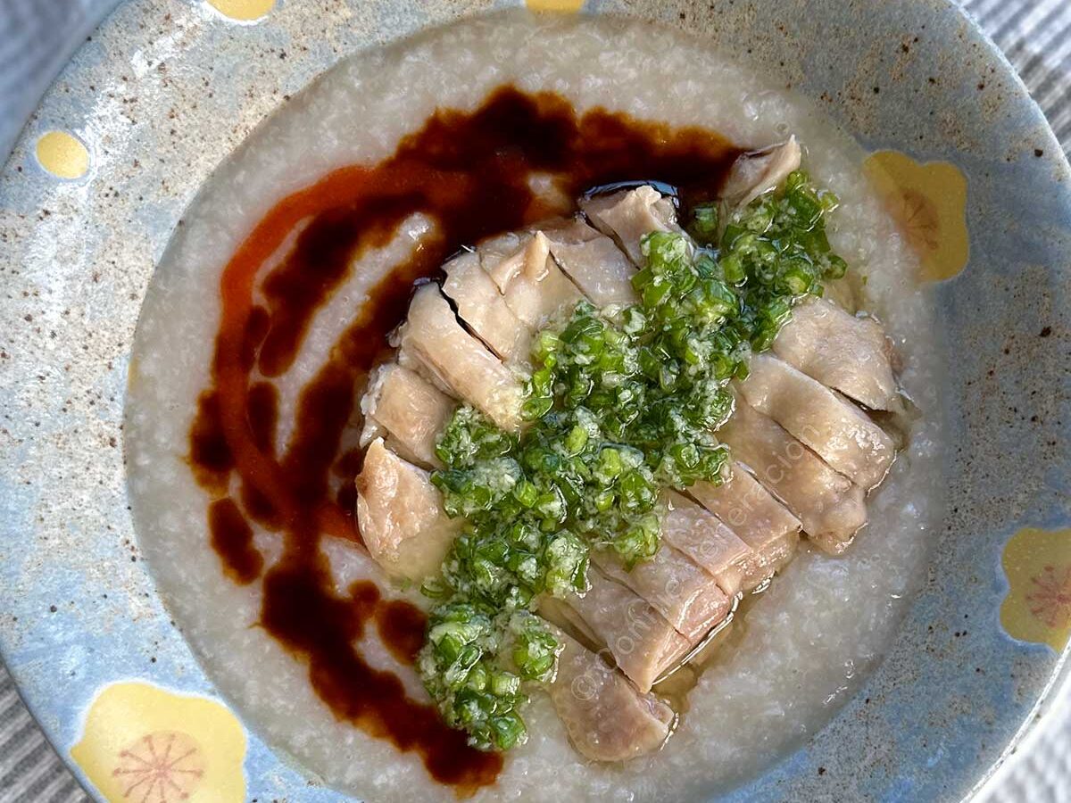 Hainese chicken congee with ginger-scallion sauce, sweet soy sauce and chili sauce