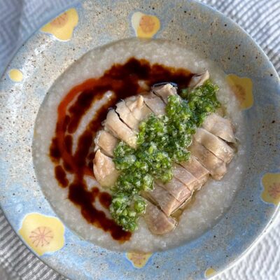 Hainese chicken congee with ginger-scallion sauce, sweet soy sauce and chili sauce