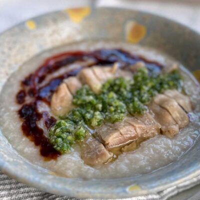 Hainese chicken congee with ginger-scallion sauce, sweet soy sauce and chili sauce