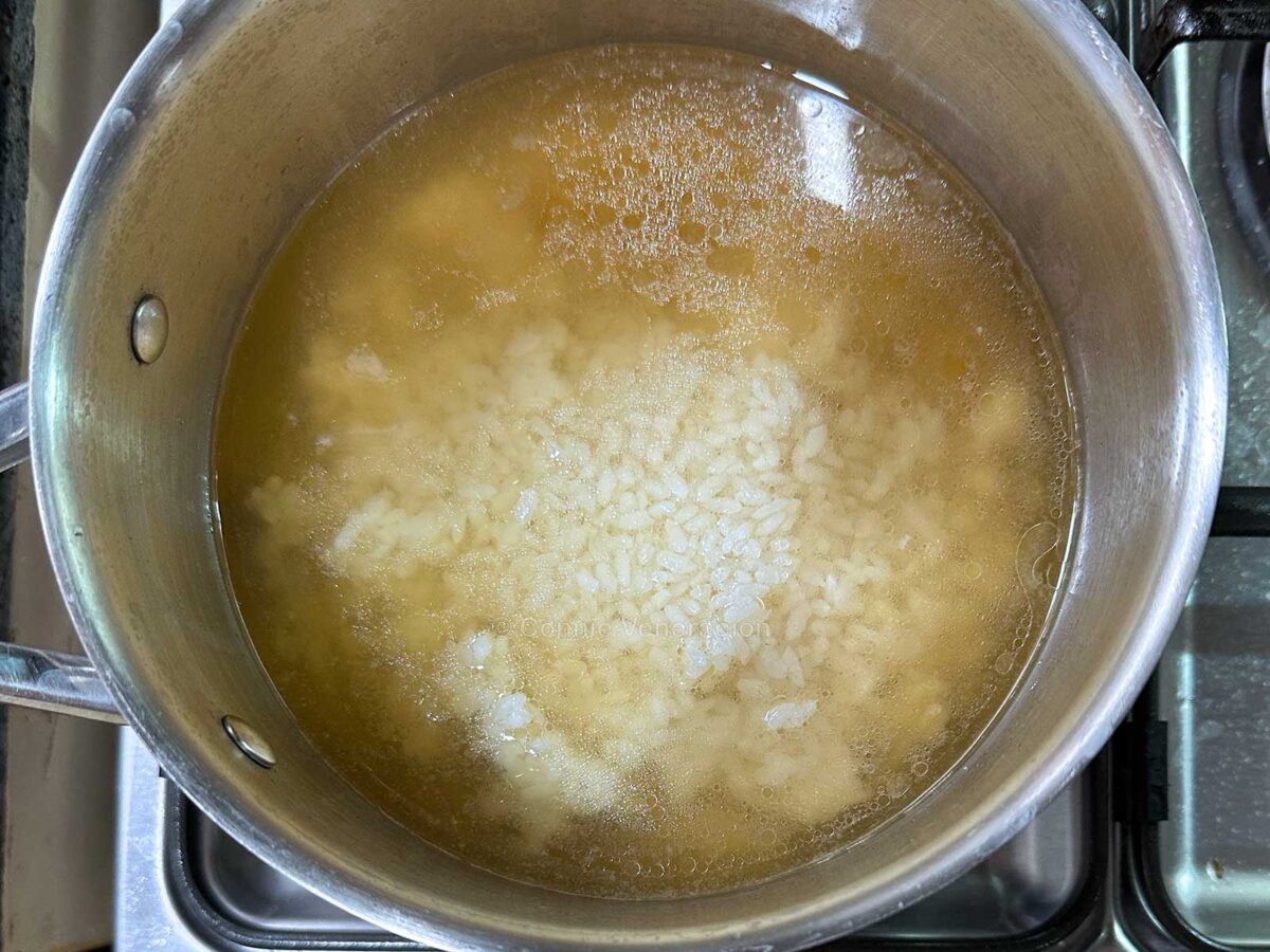 Adding leftover rice to chicken bone broth to make congee